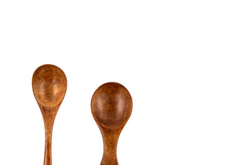 Empty wooden spoons isolated on white background, close up