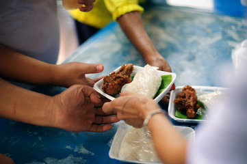 Homeless Concepts and Poverty : The hands of the poor receive food from the hands of the philanthropist : concept of giving