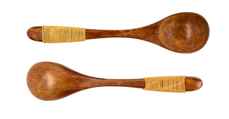 Empty wooden spoons isolated on white background, close up