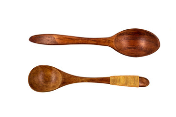 Empty wooden spoons isolated on white background, close up