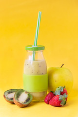 kiwi and apple smoothies on a yellow background