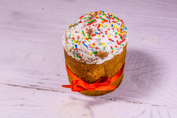 Ukrainian easter bread kulich on a white wooden table