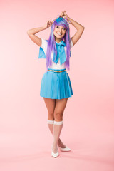 Full length view of pretty anime girl in wig and sailor suit standing on pink