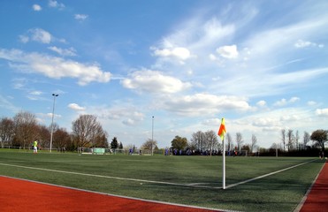 soccer players on the Pitch with corner flag, blue sky background