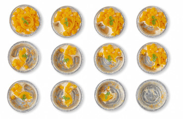 Mango cheesecake in aluminum foil cup isolated over white background.