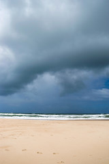 Stormy sky and clear sand on a tropical beach