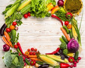 vegetables laid out on a table in a circle with space for text