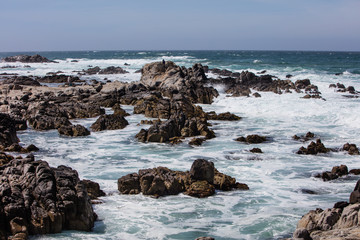 Fototapeta na wymiar The nutrient-rich waters of the Pacific Ocean washes against the beautiful, rocky California coastline just south of Monterey Bay. This area is known for its spectacular natural scenery.