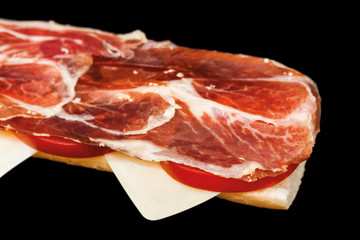 Closeup of a Spanish serrano ham toast. Selective focus.