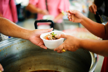 Charity food is the hope of the poor who have no money : concept of begging food : Donate food to people in society : Volunteers Share Food to the Poor