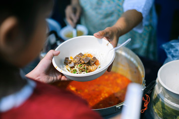 Charity food is the hope of the poor who have no money : concept of begging food : Donate food to people in society : Volunteers Share Food to the Poor