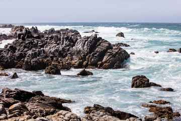 Fototapeta na wymiar The nutrient-rich waters of the Pacific Ocean washes against the beautiful, rocky California coastline just south of Monterey Bay. This area is known for its spectacular natural scenery.