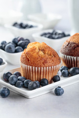 Muffins and blueberry on white table.
