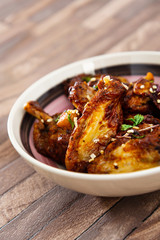 Chicken Wings Spicy chicken wings, breaded, fried, cooked.