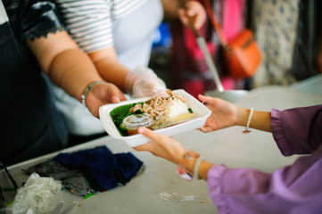 Beggar begs food from donors: Caring for fellow human beings in society by giving food, Giving...