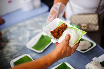 Beggar begs food from donors: Caring for fellow human beings in society by giving food, Giving...