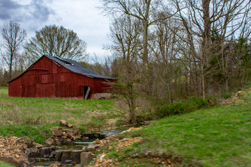 Old Wood Barn Behine a Creek