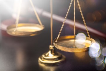 Justice Scales and wooden gavel on wooden table
