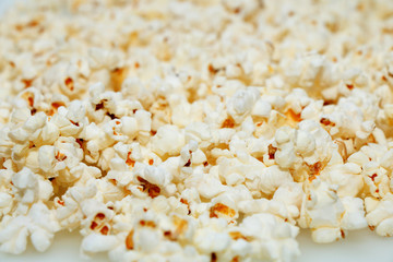 Fresh hot popcorn scattered on the table