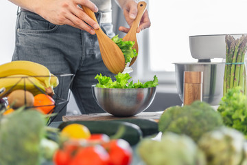 Young man chef cooking healthy salad