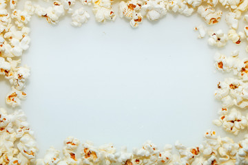Frame of fresh hot popcorn scattered on the table