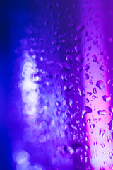 violet blue drops on glass surface, macro, abstraction