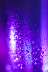 violet blue drops on glass surface, macro, abstraction