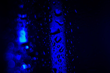 dark blue drops on the glass surface, macro, abstraction