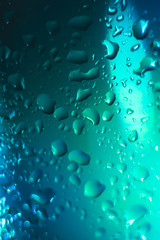 blue with a turquoise drop on a glass surface, macro, abstraction