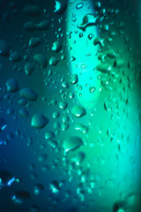 blue with a turquoise drop on a glass surface, macro, abstraction