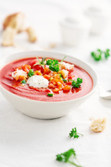 Tasty summer tomato soup served in bowl