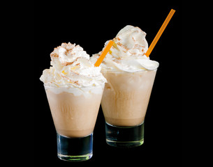 Frappe coffee with cream and cinnamon isolated on a black background