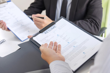 Employer or recruiter holding reading a resume during about colloquy his profile of candidate,...