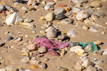 Plastic bags washed up from the Atlantic Ocean sand beach shoreline in Agadir, Morocco