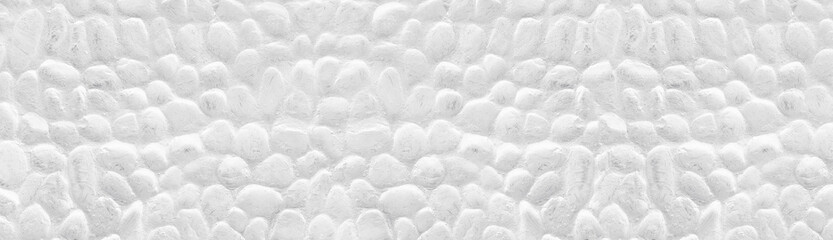 Whitewashed stone wall wide panoramic texture. White painted stones panorama. Long light background
