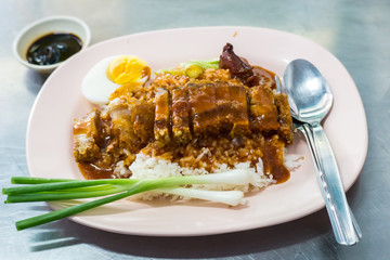 Barbecued red pork in sauce and crispy pork with rice and boiler egg