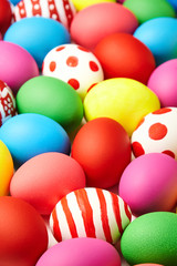 Fototapeta na wymiar Colorful Easter eggs background. Christian holiday traditions. Traditional symbol. Ceremonial food