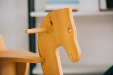 Selective focus of wooden rocking horse in living room