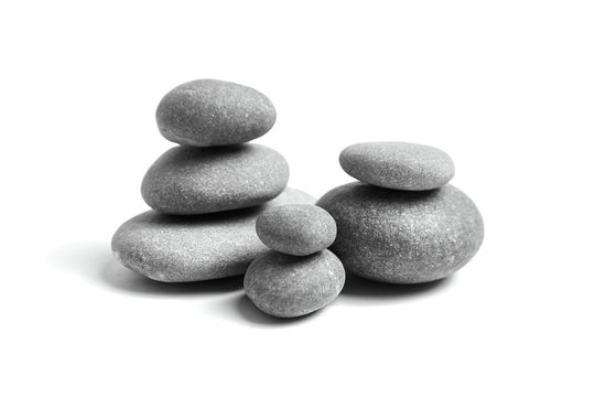 Stacked pebbles isolated on white background. Group of smooth grey stones. Sea pebble