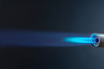 torch blue flame against black, close up