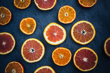Orange Slices on Dark Textured Background