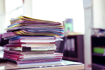 Stack of documents placed on a business desk in a business office.