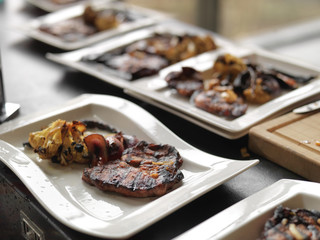 plates with cooked meat and vegetables