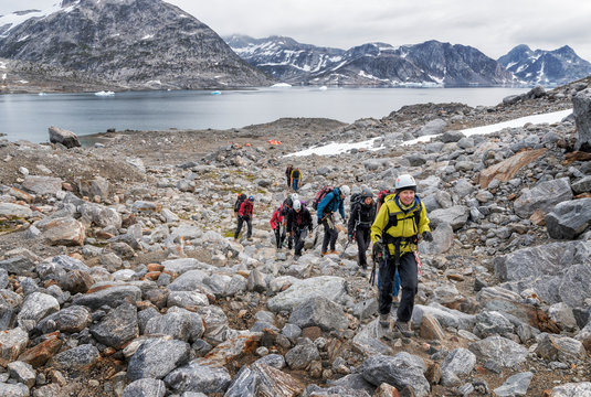 Greenland, Sermersooq, Kulusuk, Schweizerland Alps, group of people walking on rocks