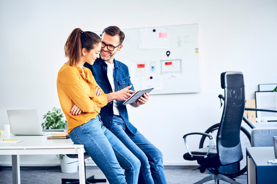 Two colleagues with tablet meeting in office