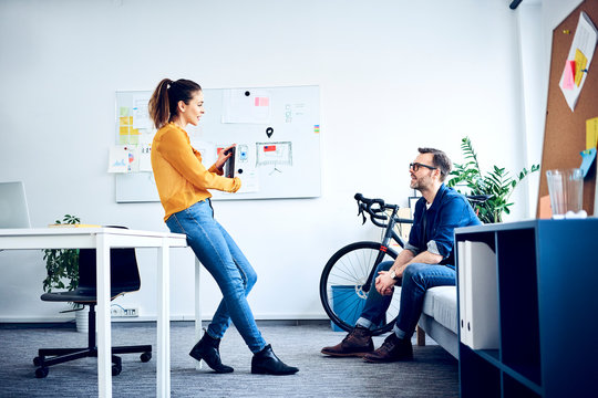 Two colleagues with tablet meeting in office