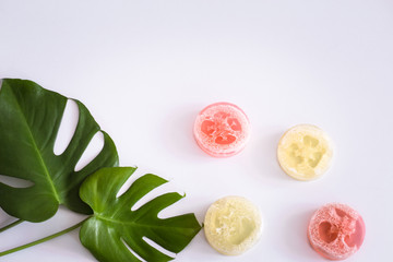 composition with tropical leaves and soap on a white background