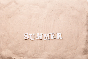 Fototapeta na wymiar Text Summer from white letters on sand.