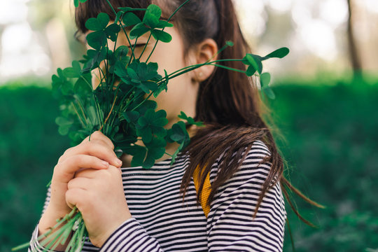 Little girl with picked clovers