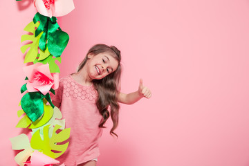 Little cute girl on color background with flowers